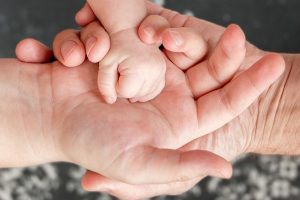 Westminster Father's Rights Attorney Three hands parents and kid child 1 300x200