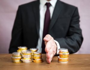 man dividing coins with his hand
