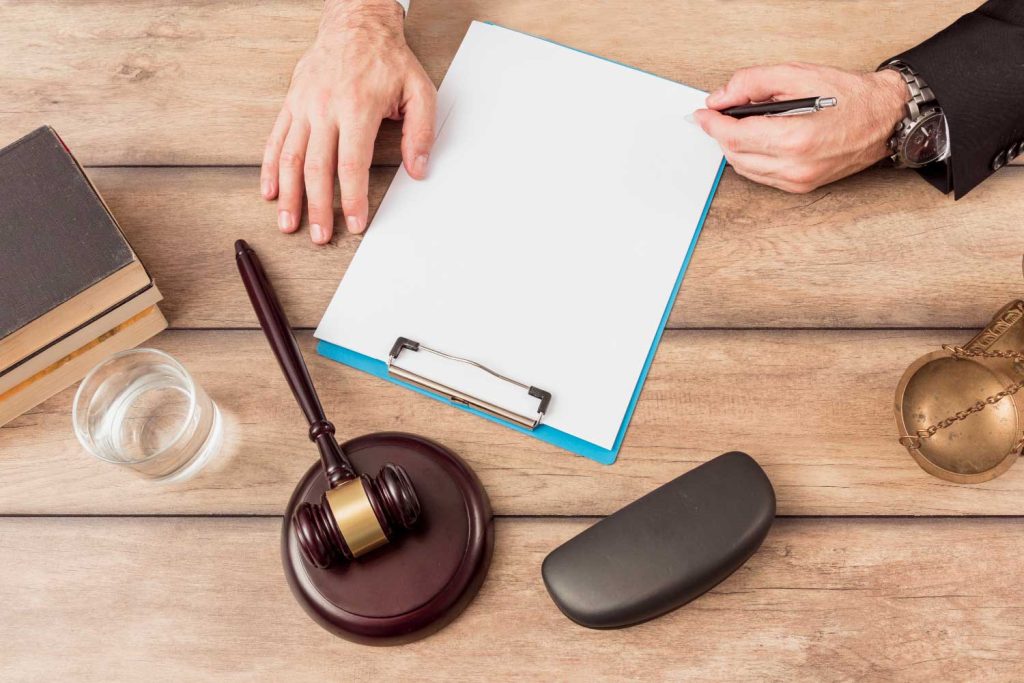 A lawyer’s desk with legal documents, a gavel, and scales of justice, symbolizing the preparation for family law cases by Davis & Associates in Columbus.